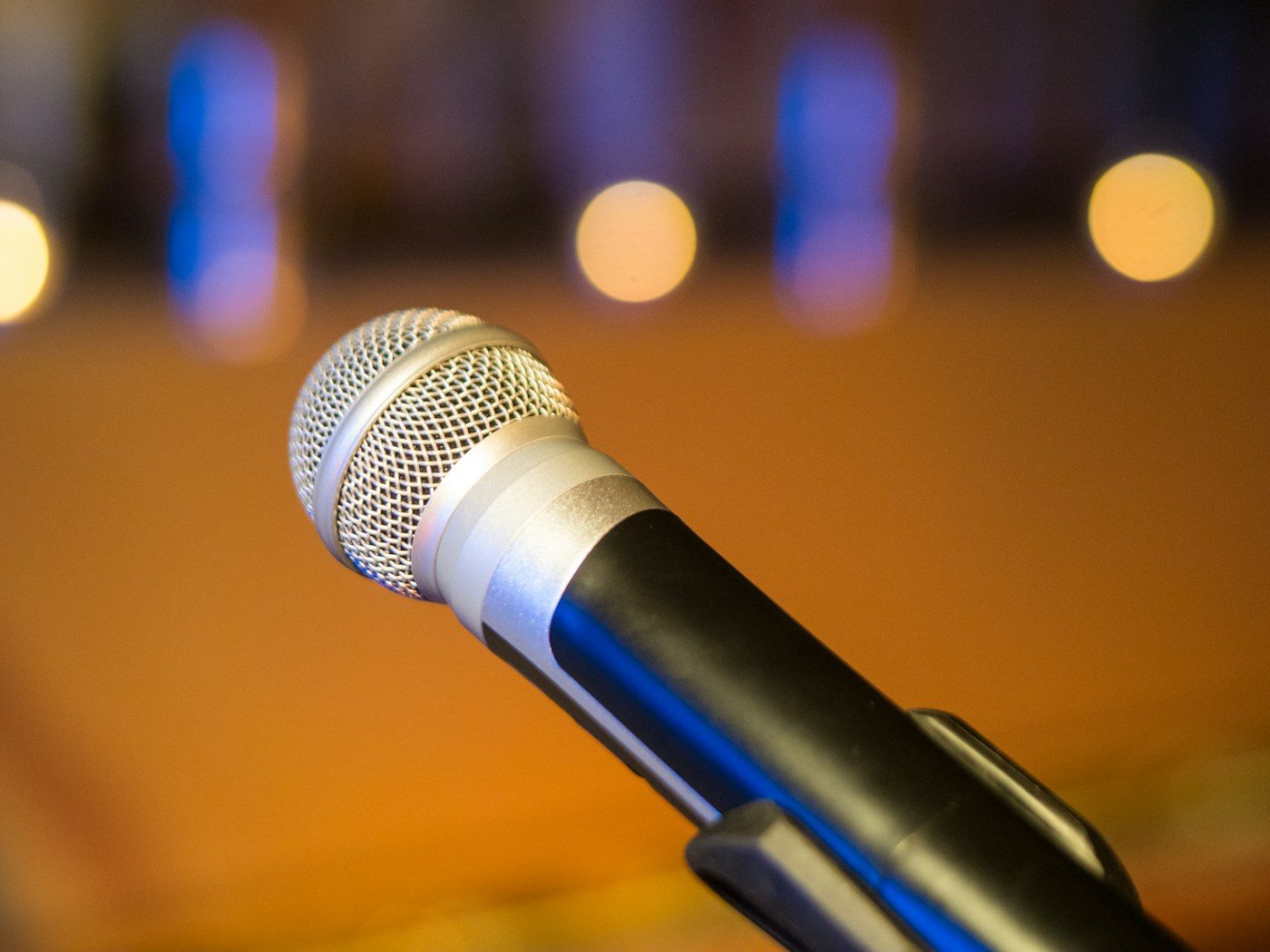 A handheld microphone on a stand, close-up, with no one behind it.